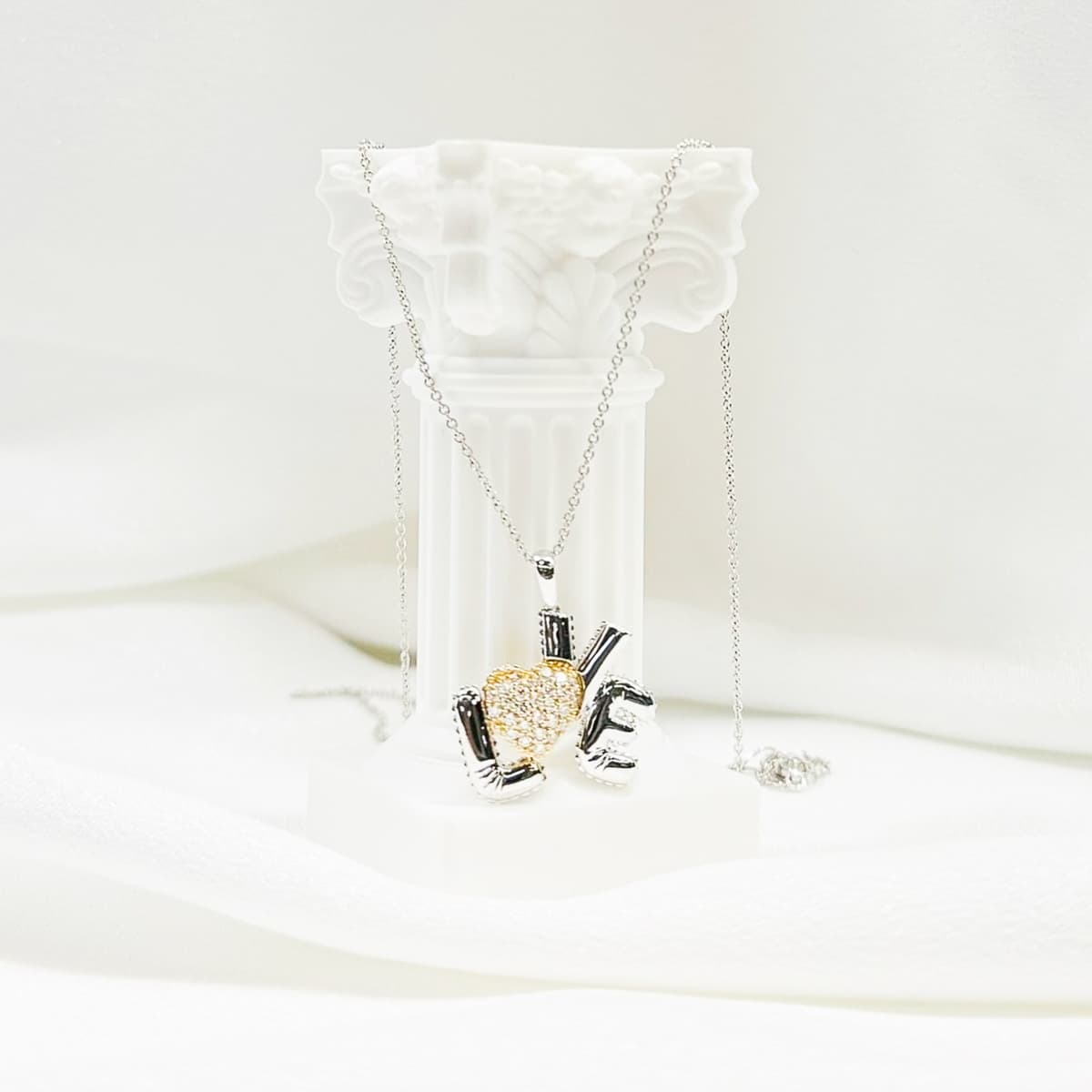 Elegant 'LOVE' pendant necklace with mixed metal design
