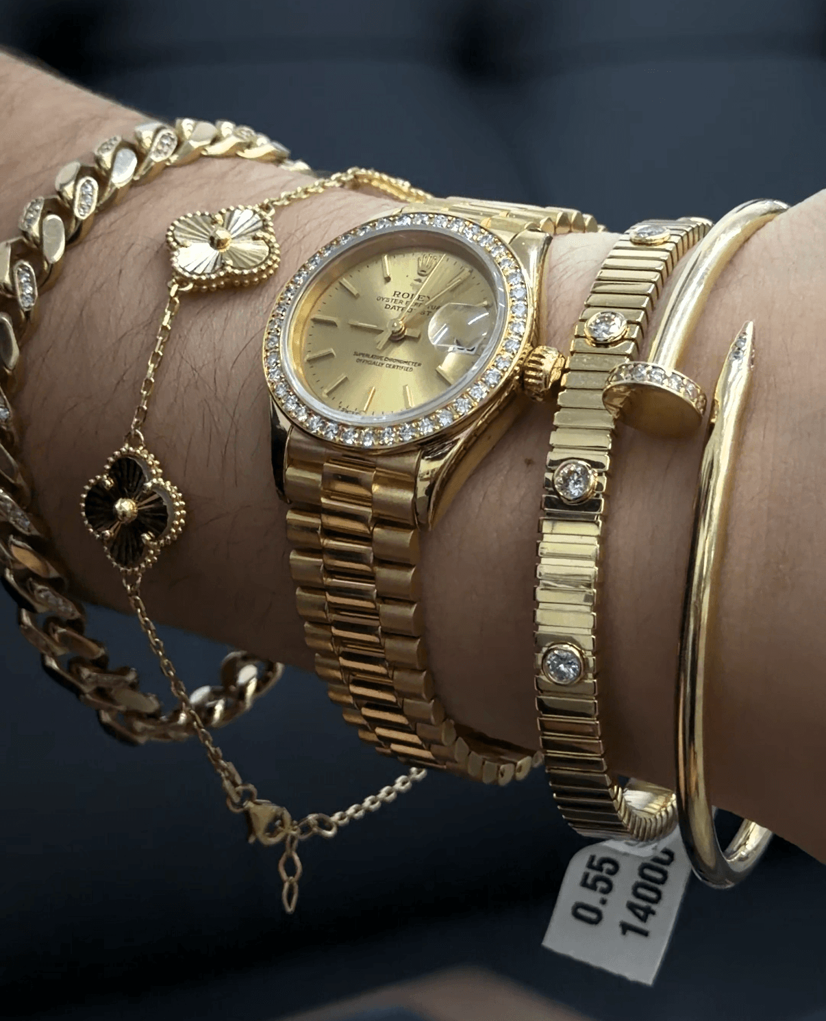 Luxury Rolex watch with diamond bracelet stack