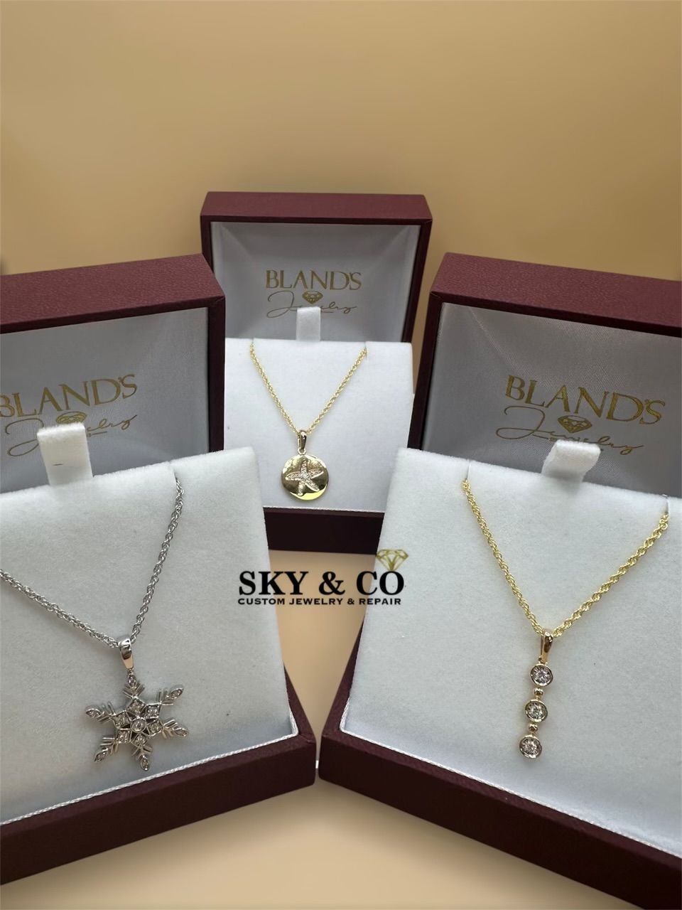 Three custom necklaces in display boxes