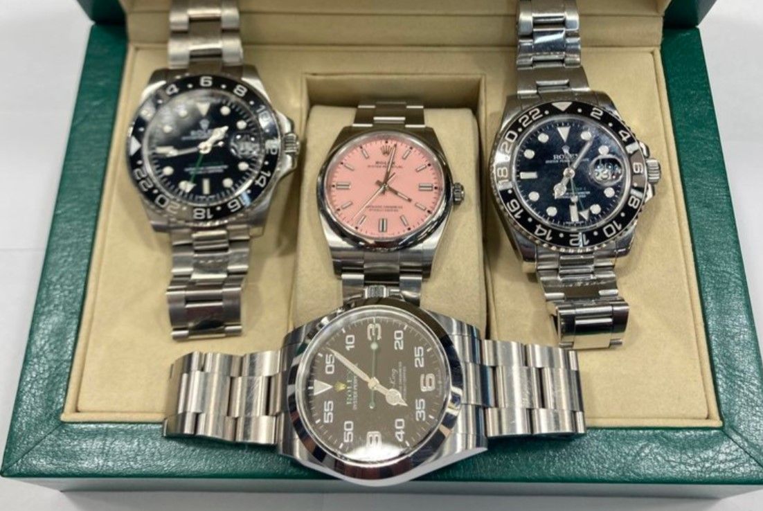 Collection of four Rolex watches in a display box