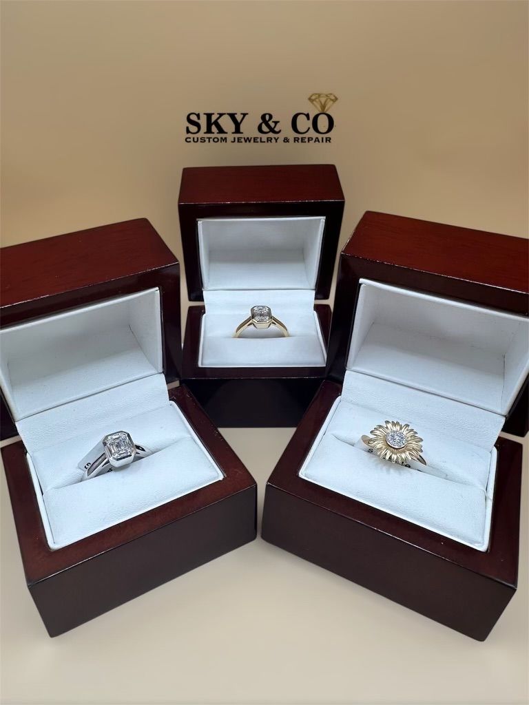 Collection of custom-designed rings in jewelry boxes